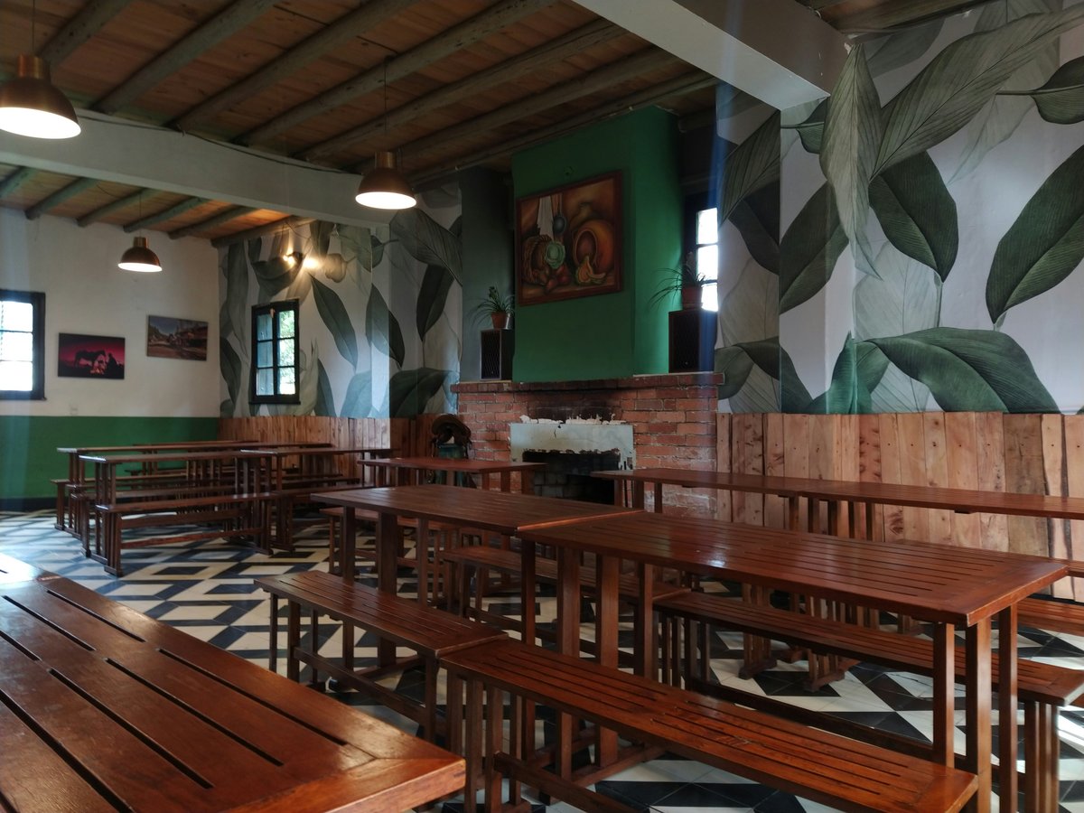 a large room with benches and tables in it