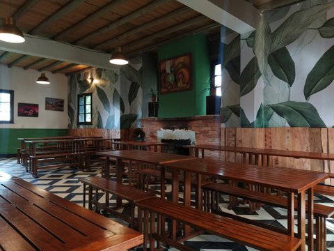 a large room with benches and tables in it