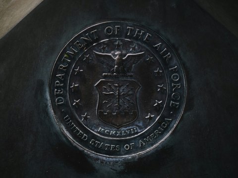 silver round coin on black textile