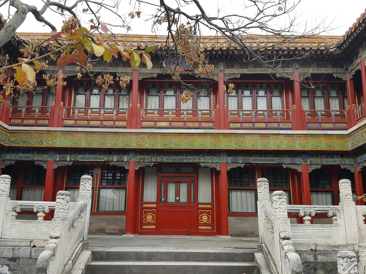 a red and green building with a red door