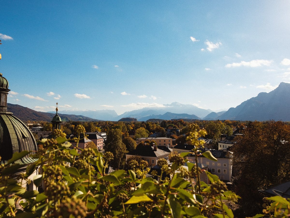a view of a town with mountains in the background