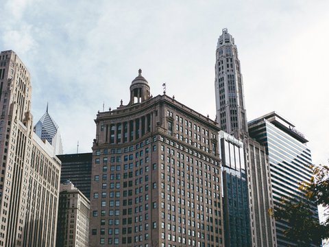 brown and white concrete building under white clouds during daytime