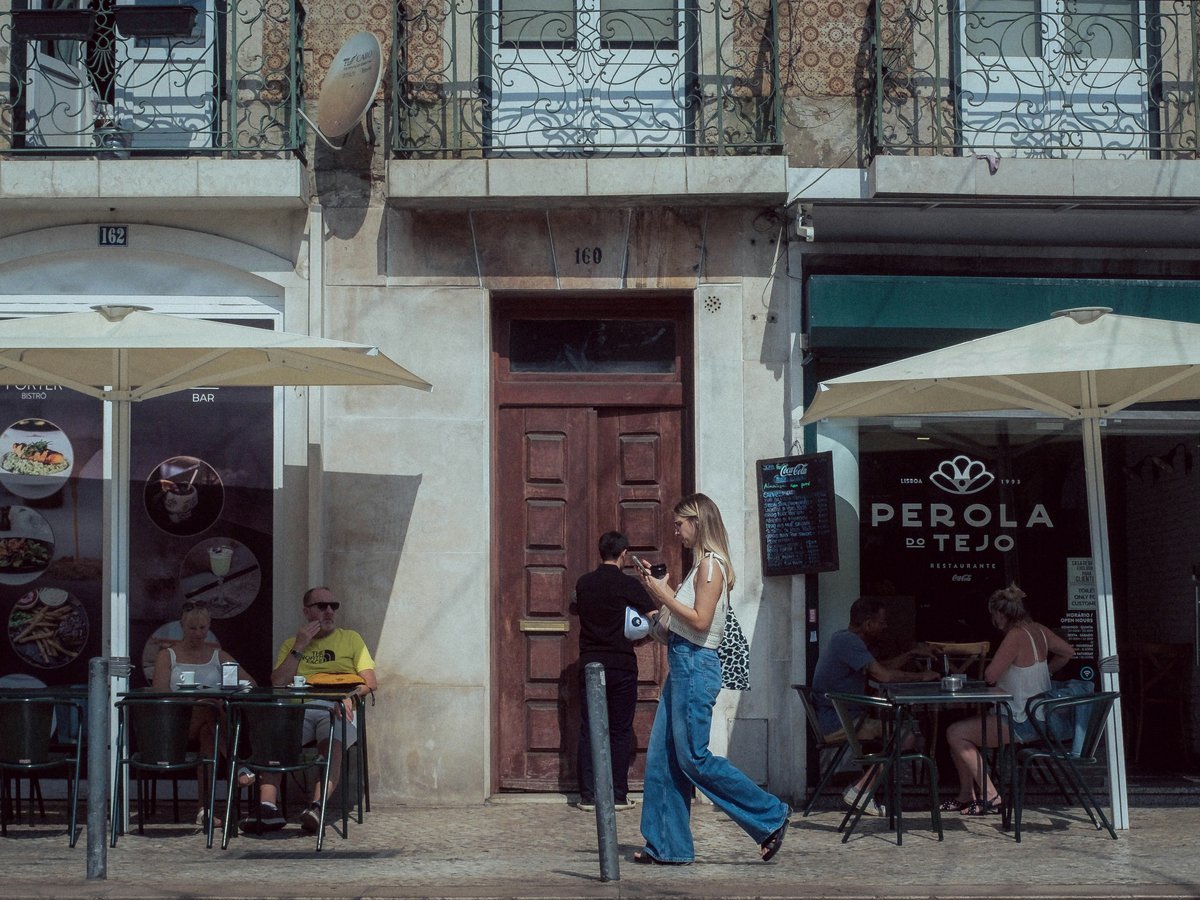 A group of people standing outside of a building