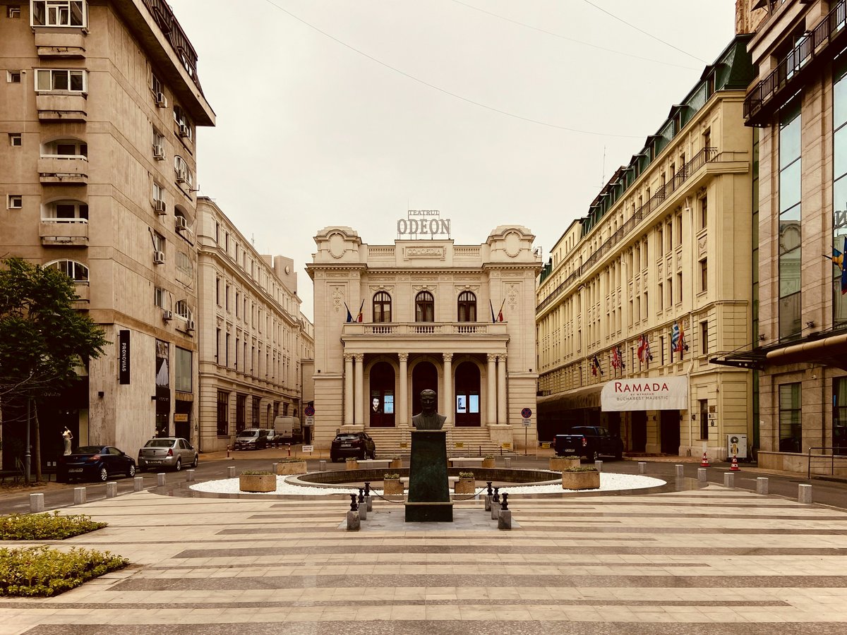 people walking on sidewalk near building during daytime