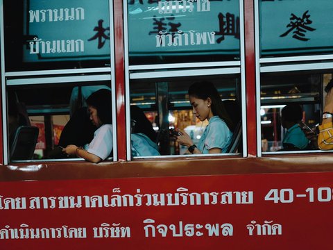 people sitting inside red bus