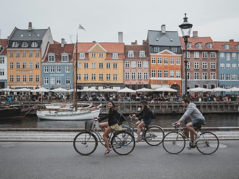 three people riding bicycles