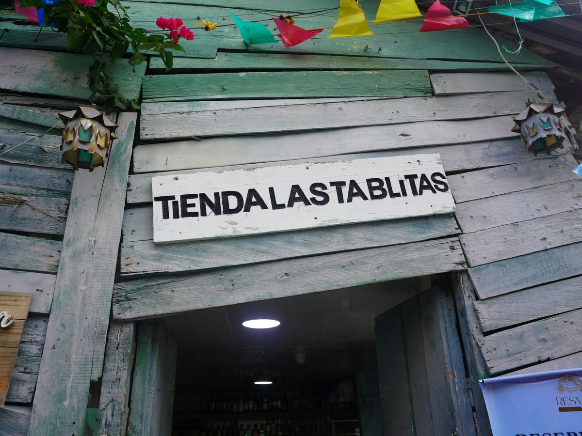 Rustic wooden shop entrance with sign tiendalastablitas