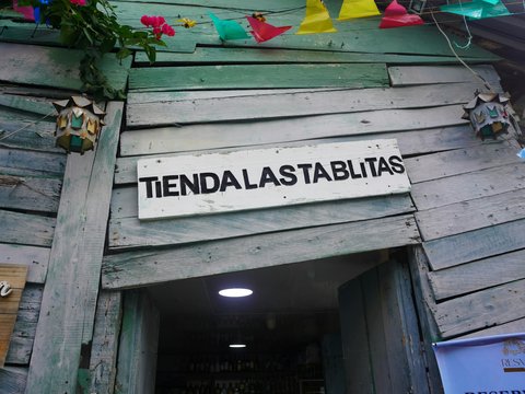 Rustic wooden shop entrance with sign tiendalastablitas