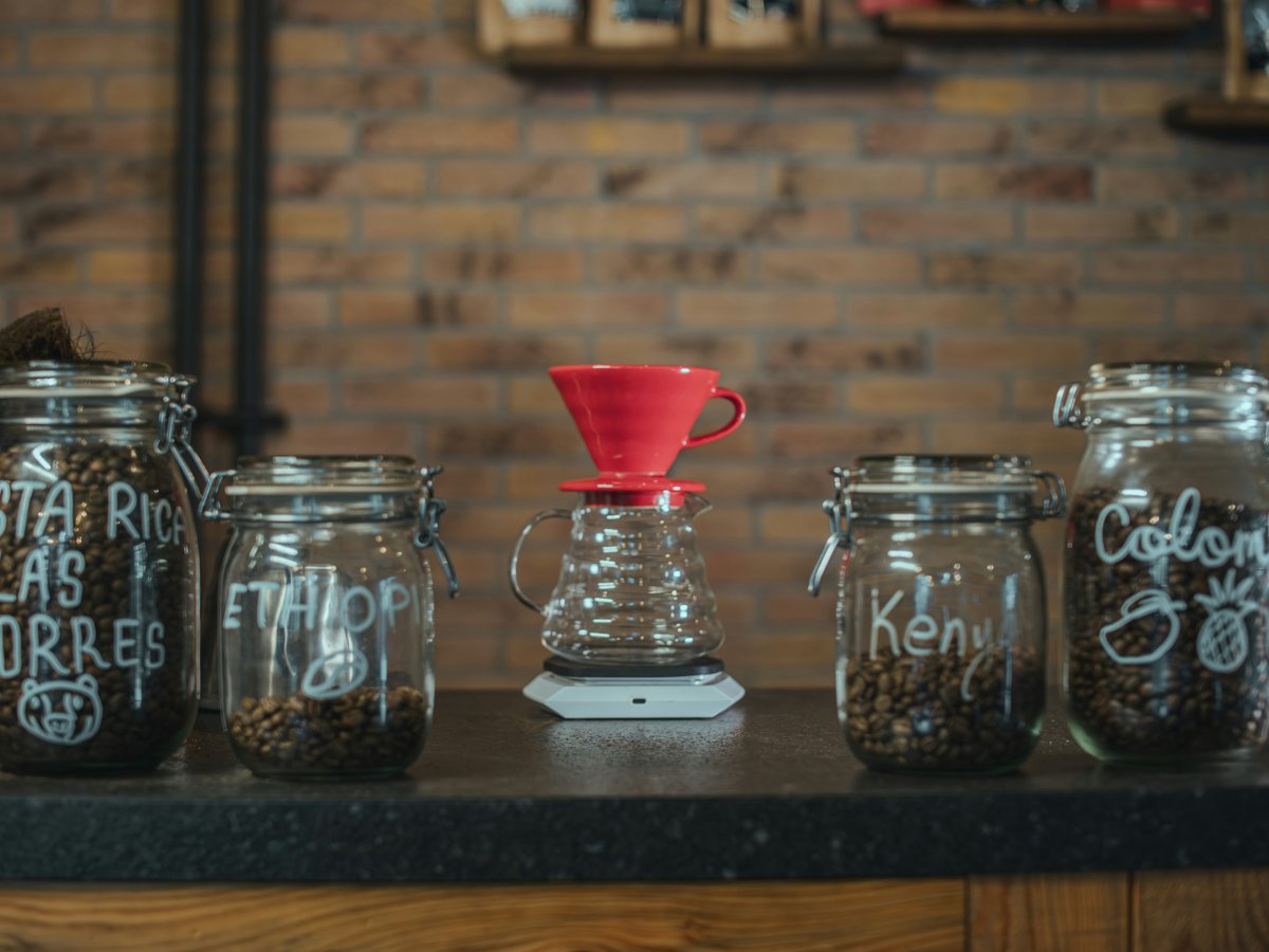 Jars of coffee beans and brewing equipment on counter