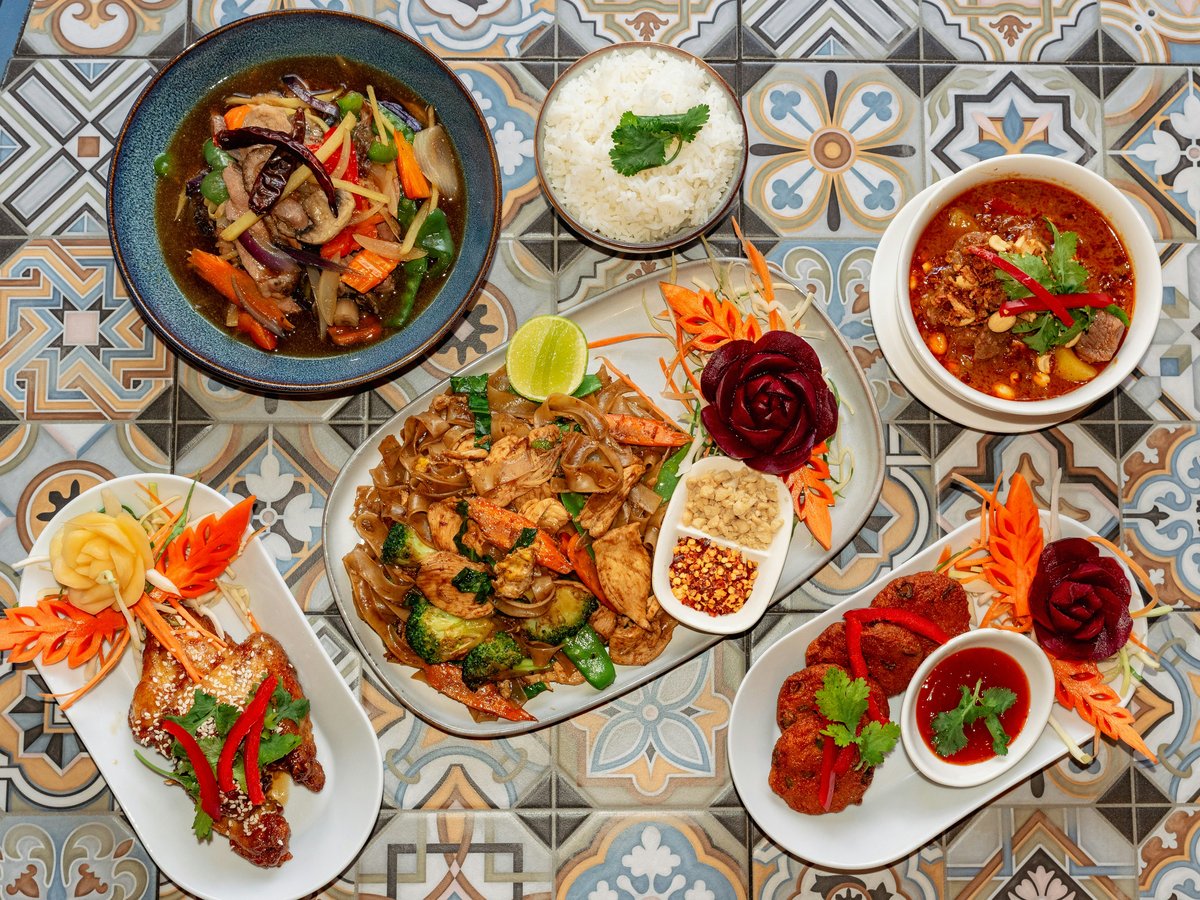 A spread of delicious thai dishes on a patterned surface