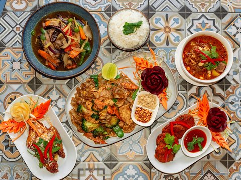 A spread of delicious thai dishes on a patterned surface