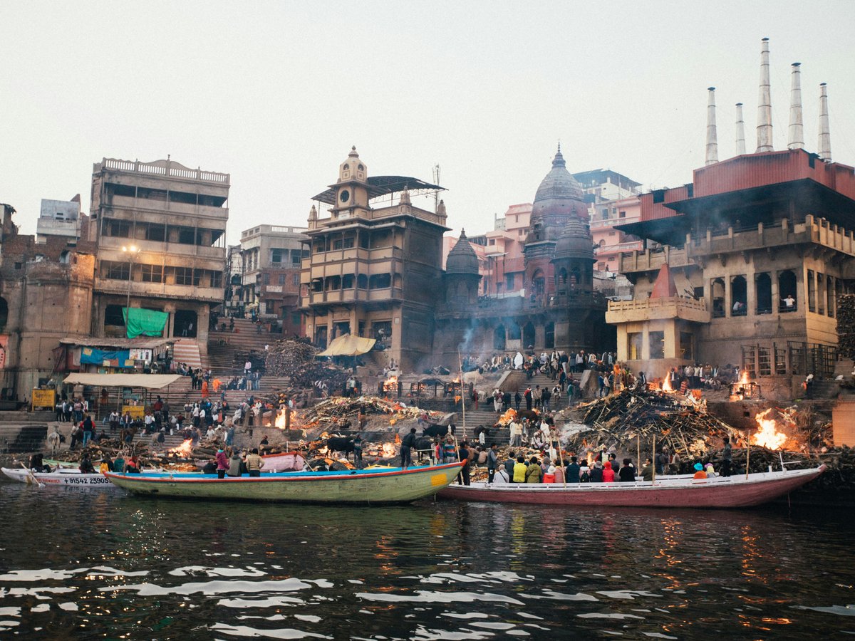 people riding on boat on river near buildings during daytime