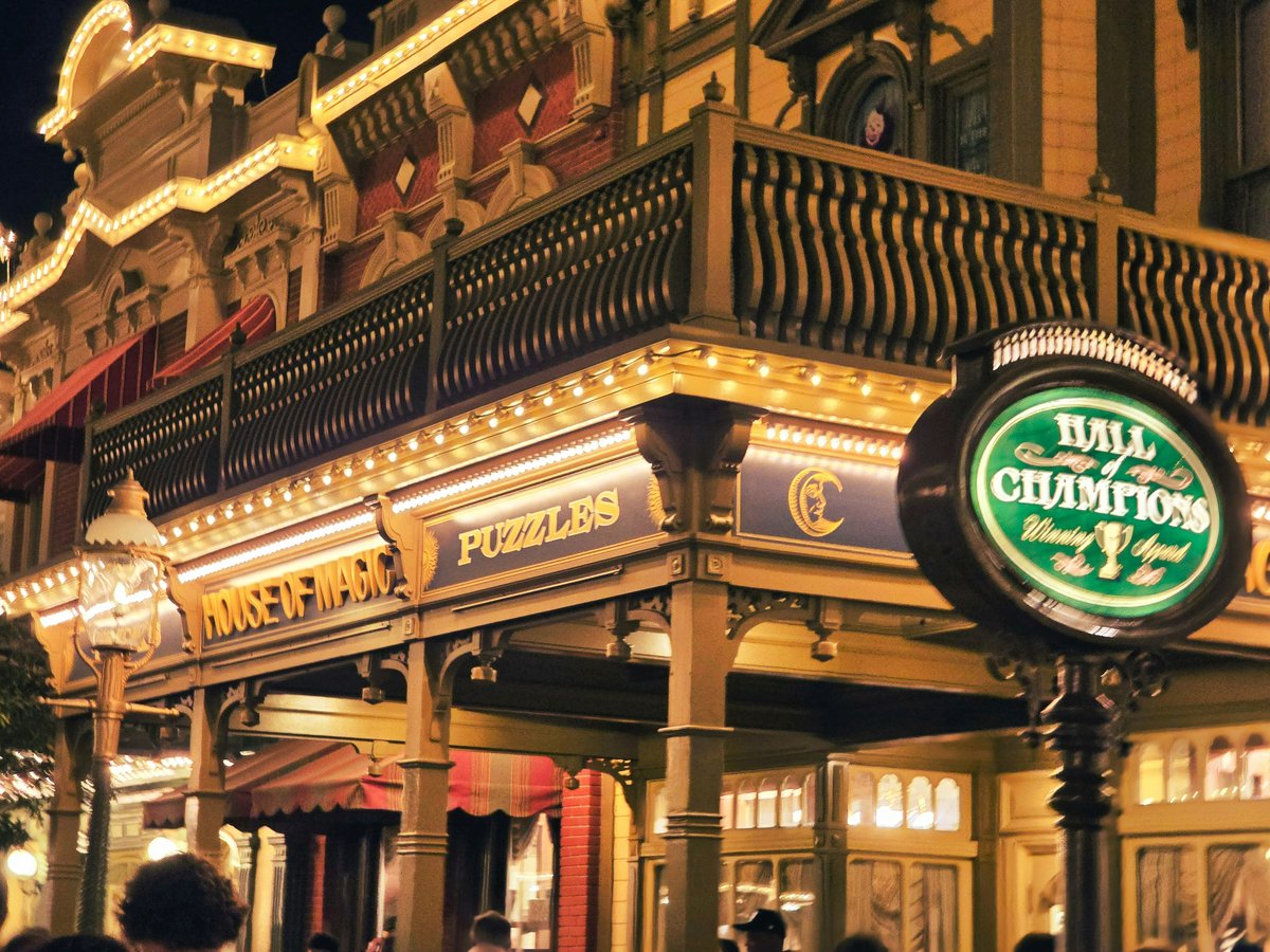 Ornate building facade illuminated at night with neon sign