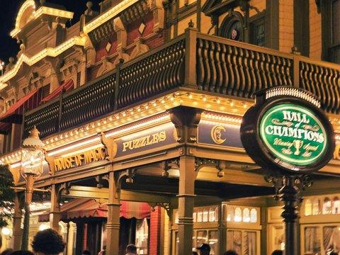 Ornate building facade illuminated at night with neon sign