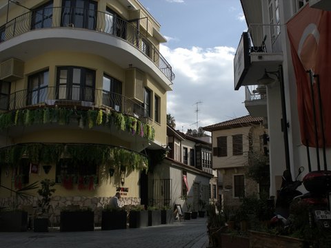 a city street with buildings and a clock tower in the background