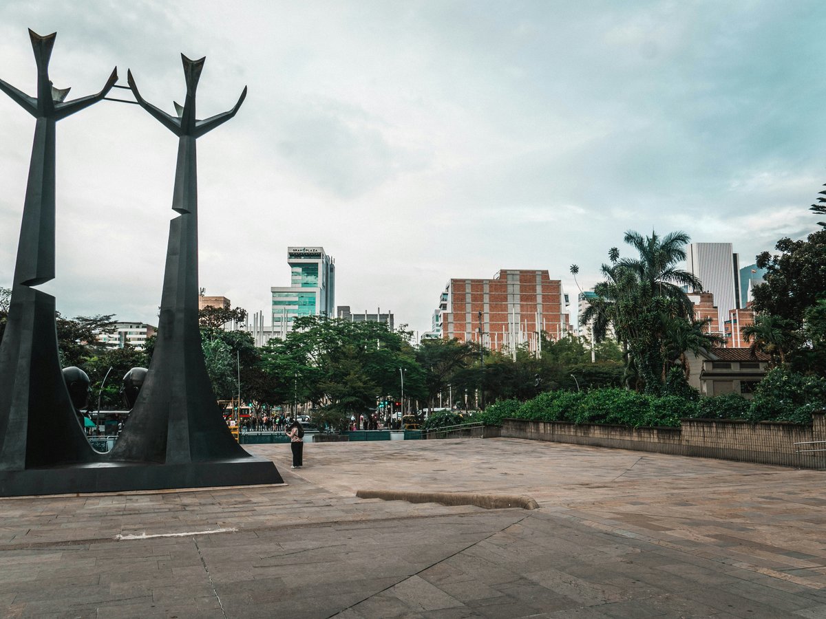 a couple of statues sitting on top of a cement ground
