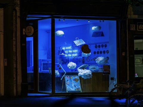 A store front with a blue light in the window