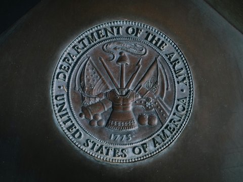 silver round coin on black textile