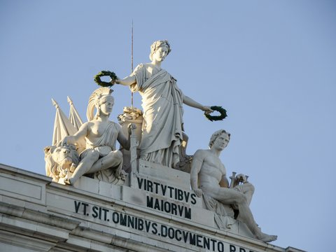 Sculptures adorn the top of a decorative arch.