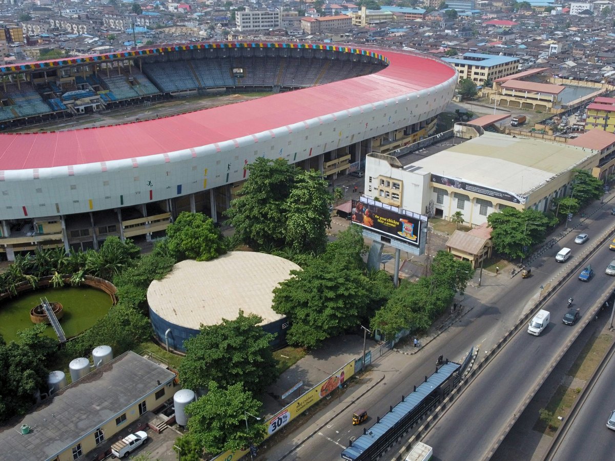 an aerial view of a soccer stadium with cars parked in front of it