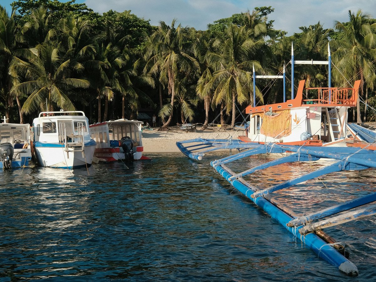 white and blue boat on body of water during daytime