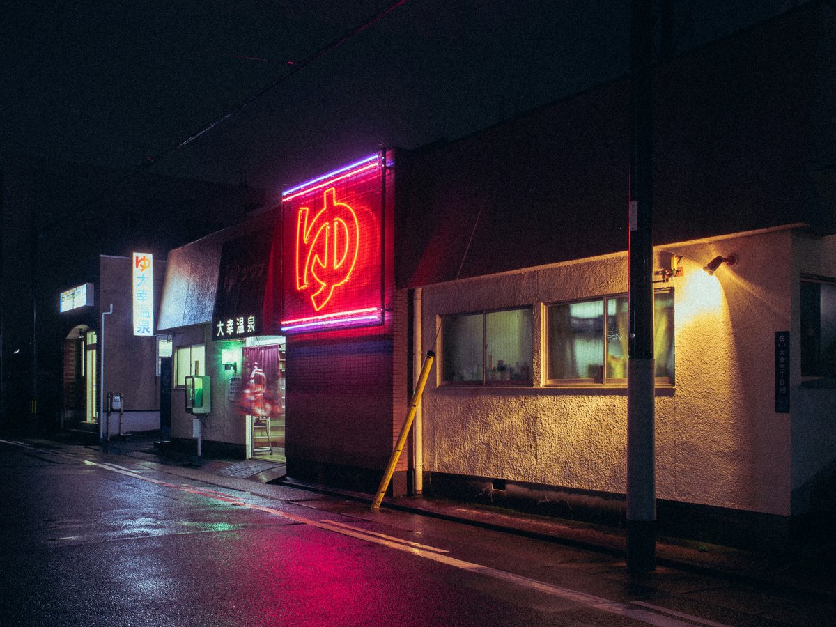 a neon sign on the side of a building