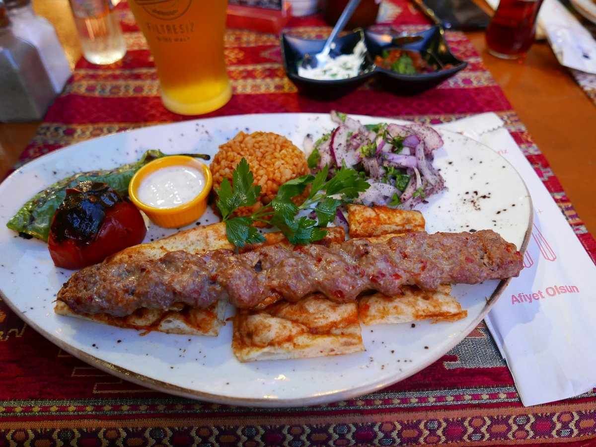 a white plate topped with meat and vegetables