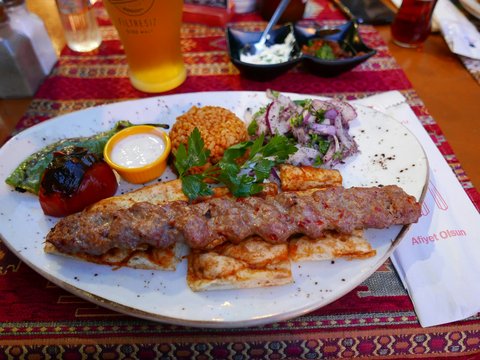 a white plate topped with meat and vegetables