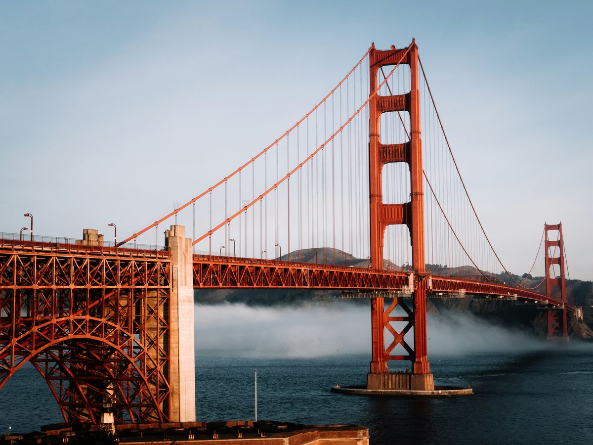 The golden gate bridge is surrounded by fog