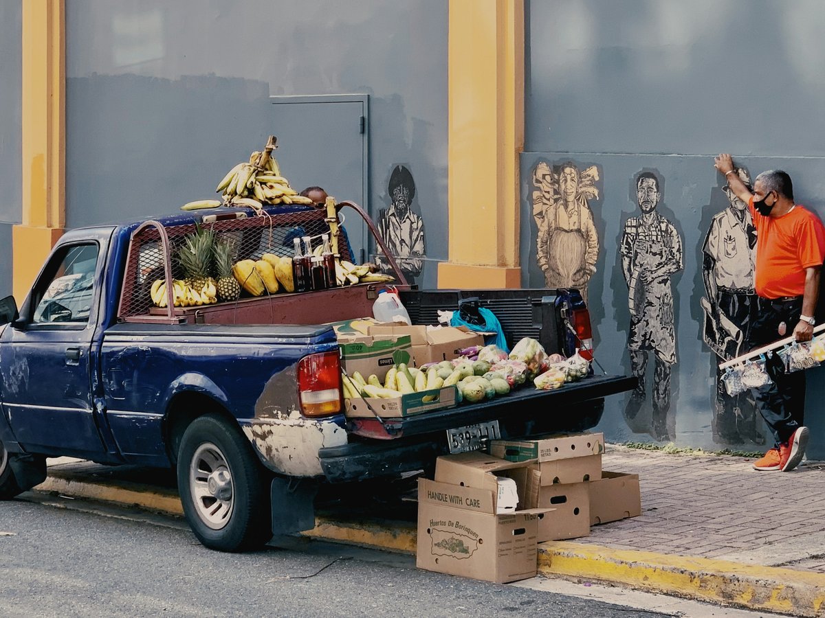 black and white single cab pickup truck with fruits and vegetables