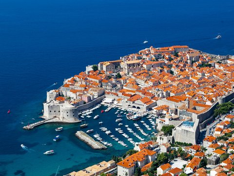 aerial view of city buildings near body of water during daytime