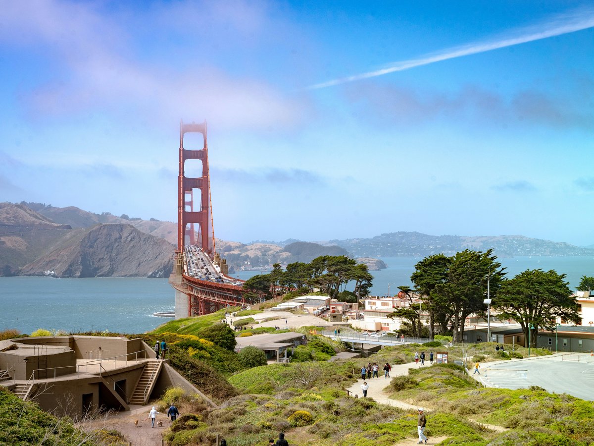 The golden gate bridge sits amidst a beautiful landscape.