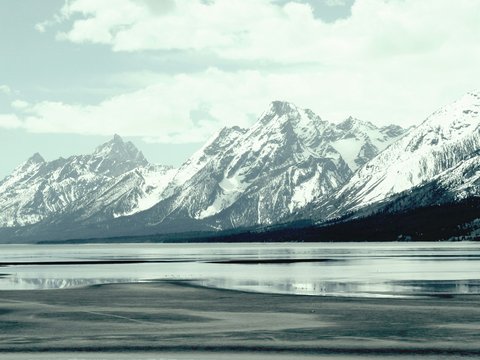 a mountain range with a body of water in front of it