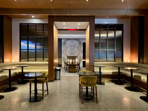 a restaurant with tables, chairs, and benches