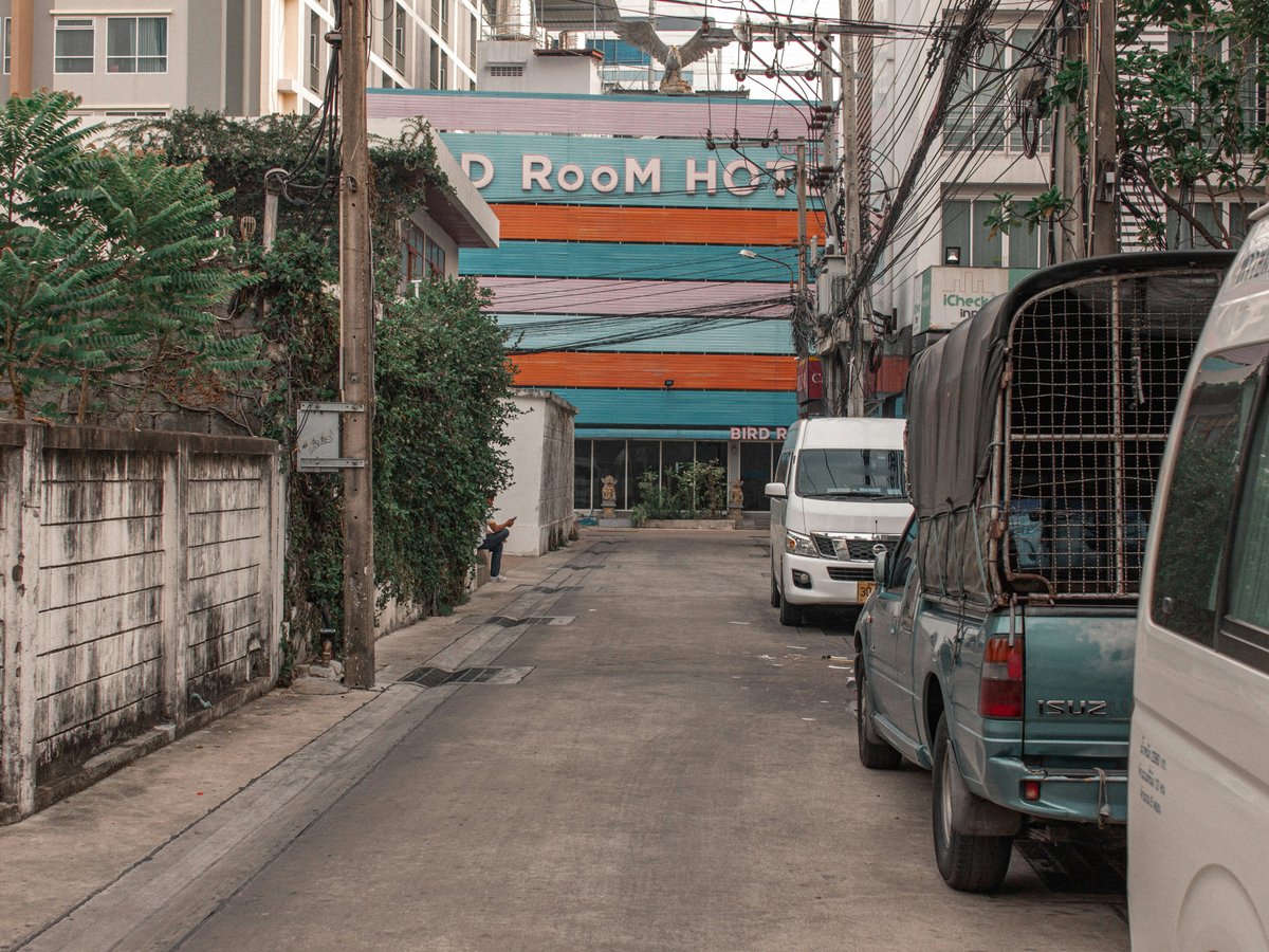 a city street with several vehicles parked on the side of it