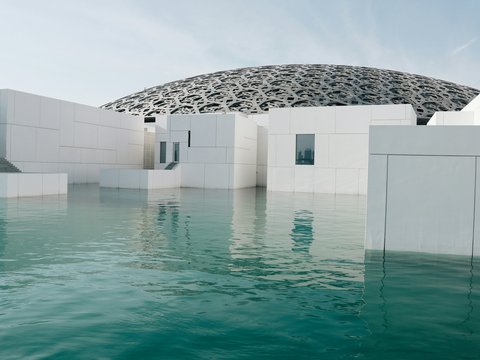 white concrete structure beside body of water