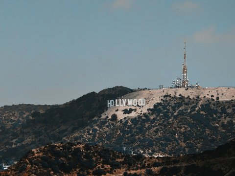Hollywood sign on a hill under a clear blue sky