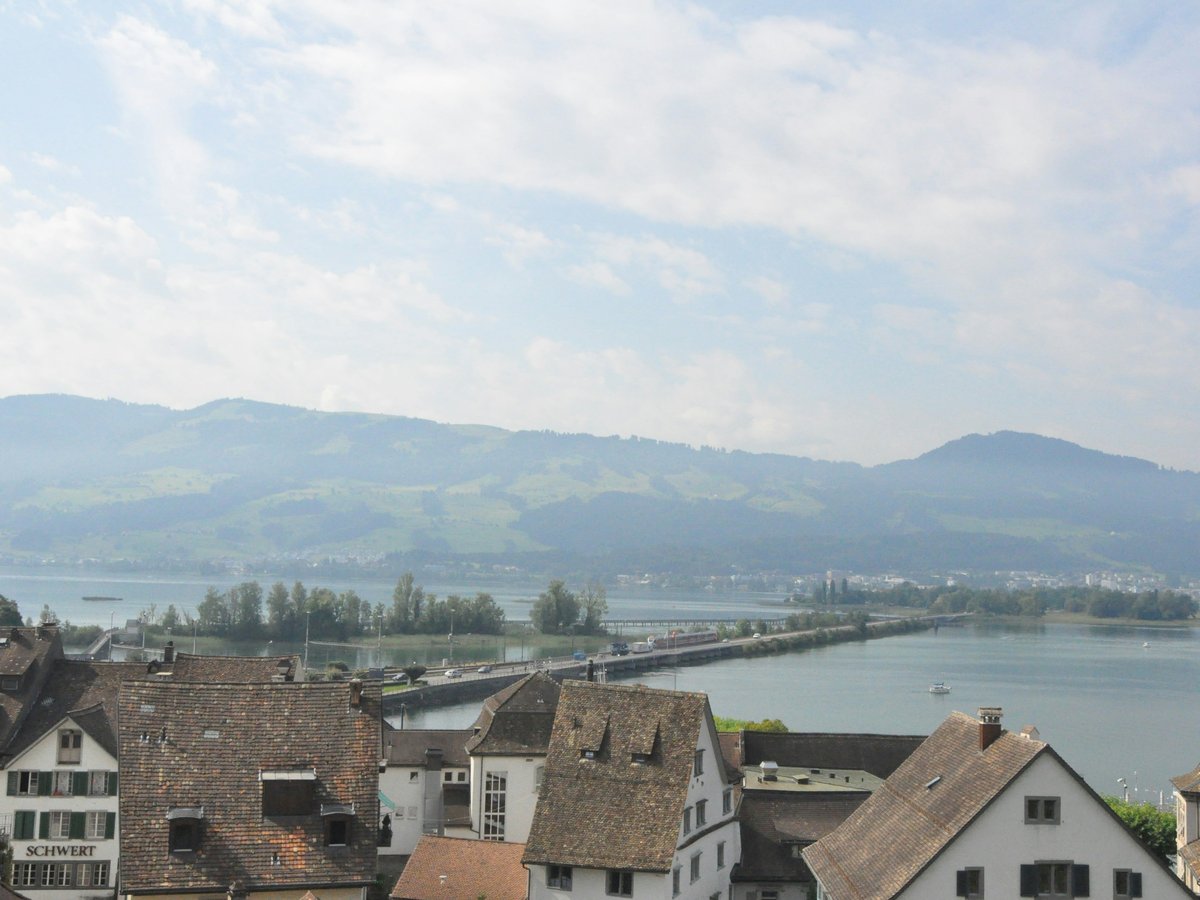 brown and white concrete houses near body of water during daytime