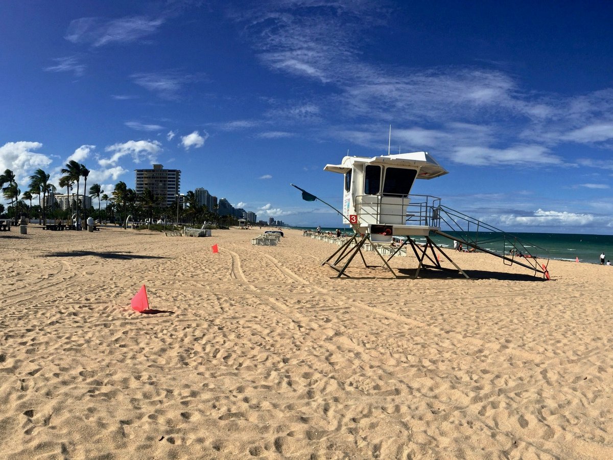 white and brown lifeguard house on beach during daytime