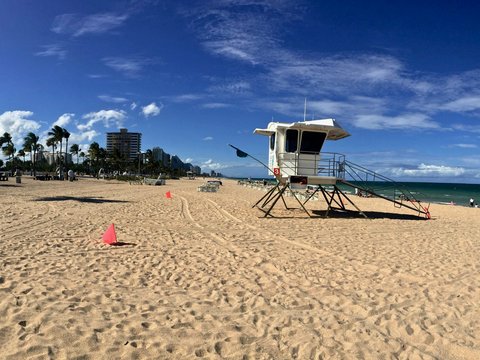 white and brown lifeguard house on beach during daytime