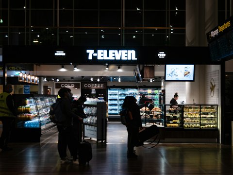 a group of people standing in front of a store