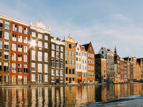 assorted-color buildings beside body of water