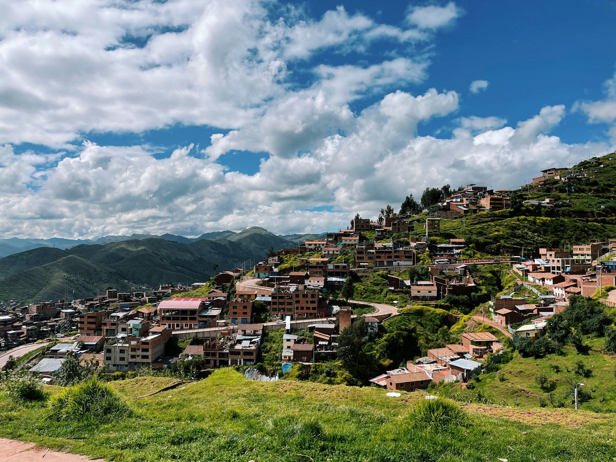 a village on a hill with a sky background