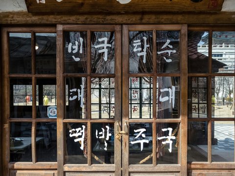 brown wooden door with glass panel at daytime