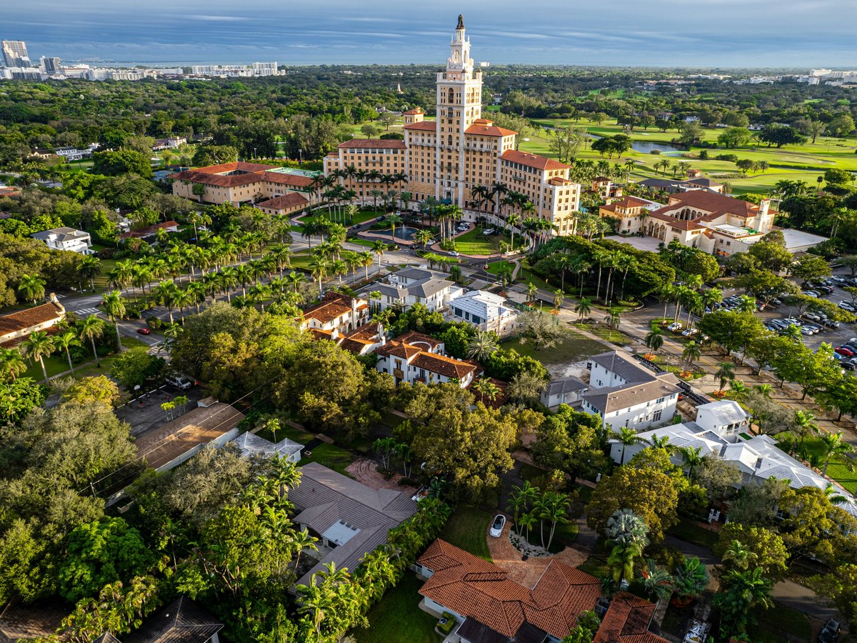 an aerial view of a city with trees and buildings