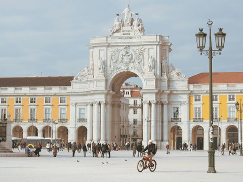 a person riding a bike in front of a building