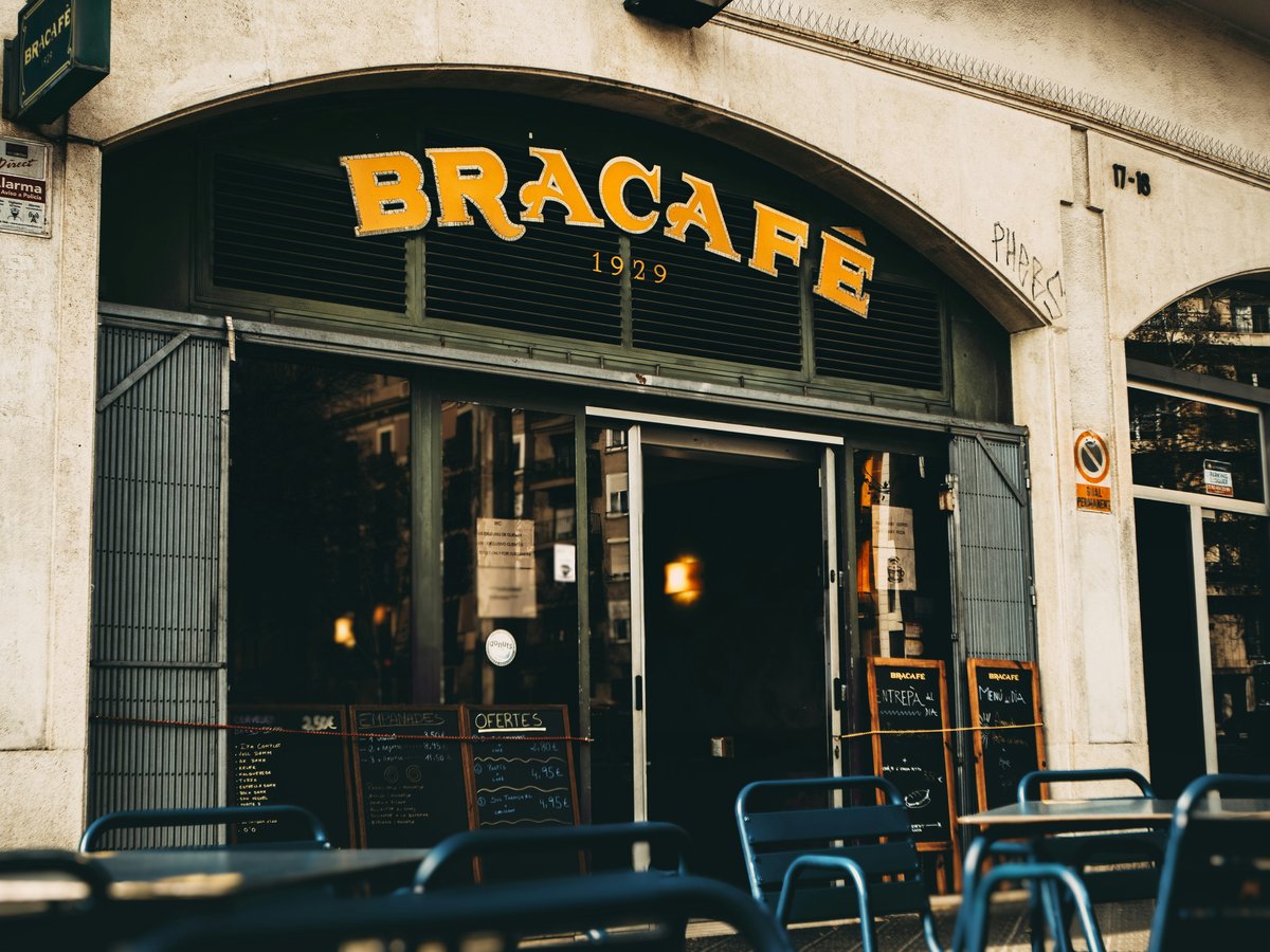 a restaurant with tables and chairs outside of it