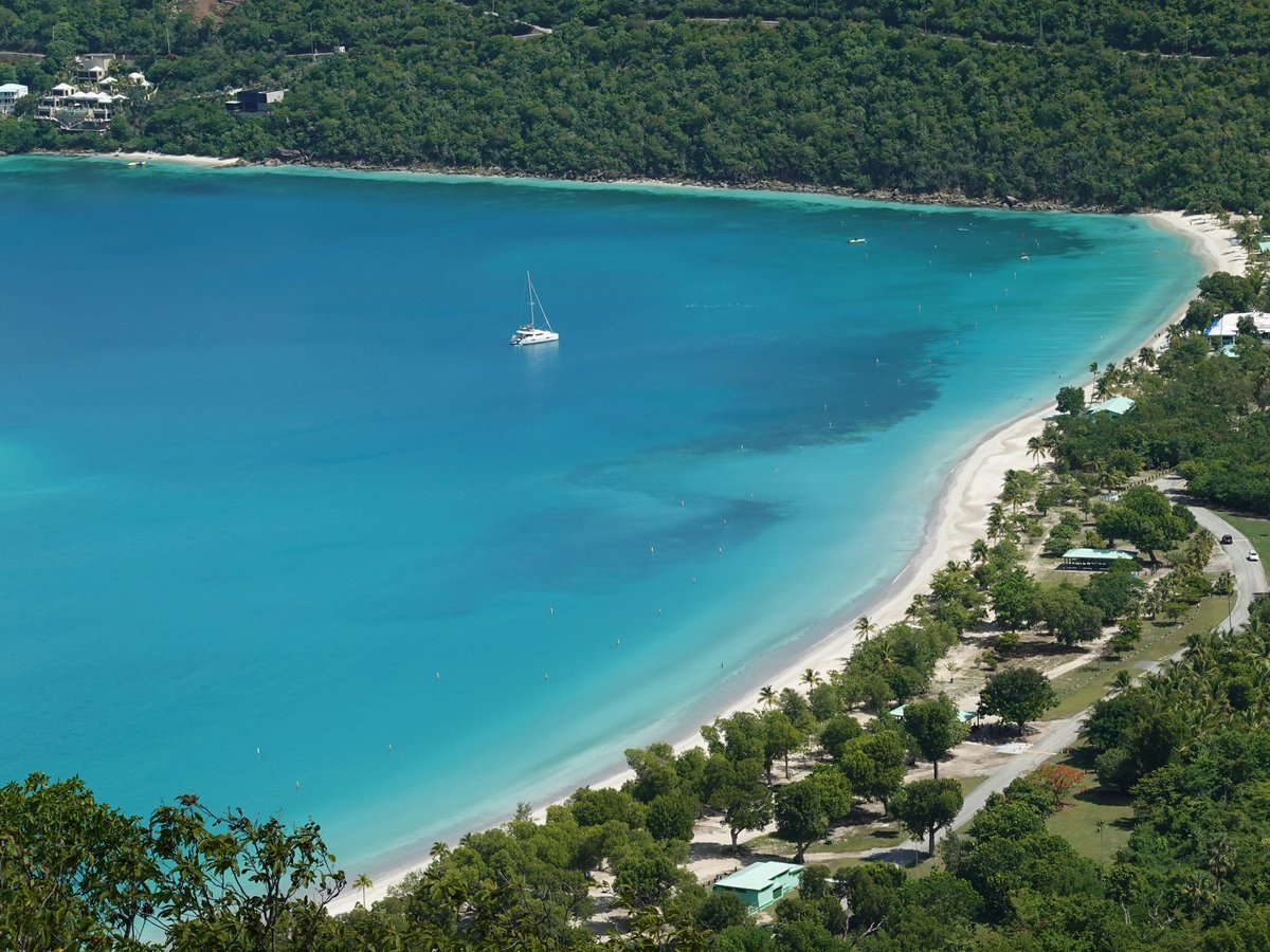 a view of a beach with a boat in the water