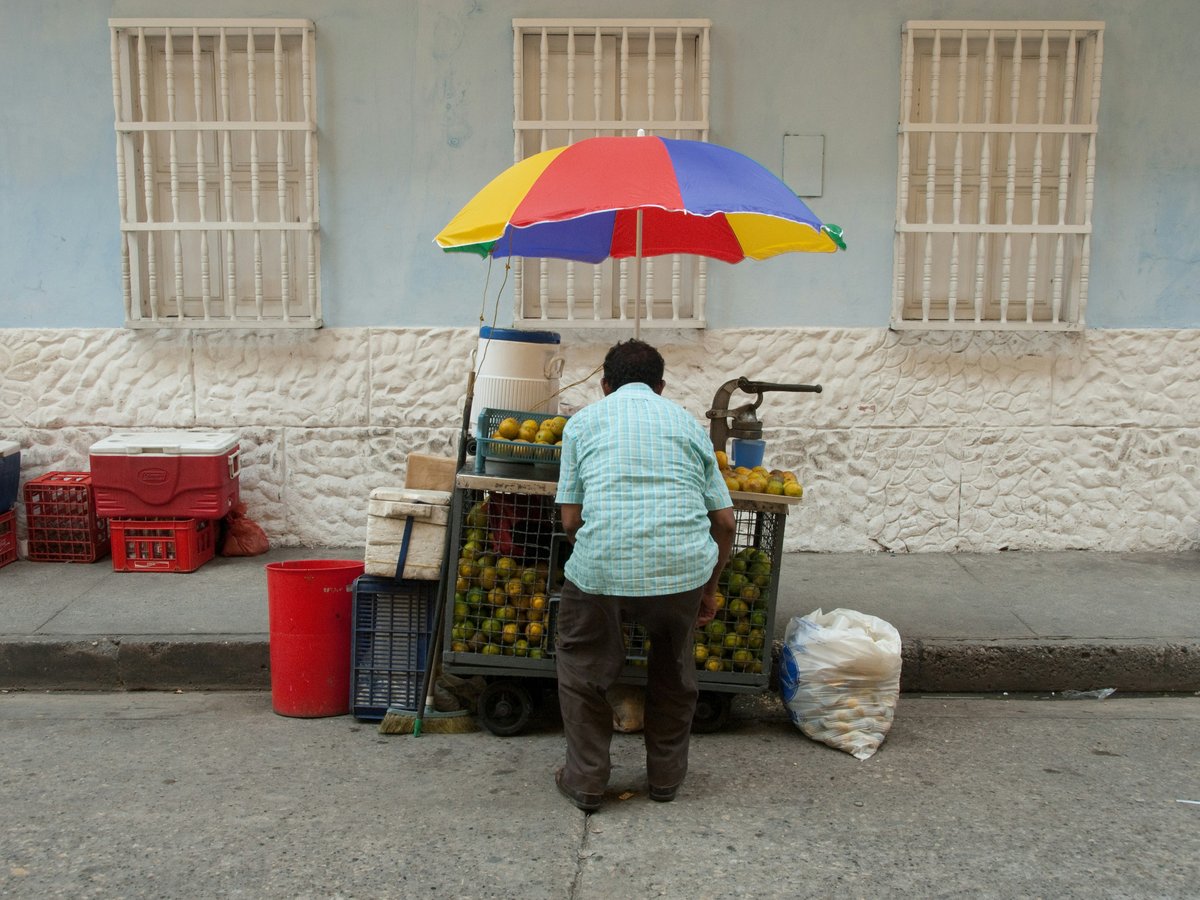 man standing near car beside street