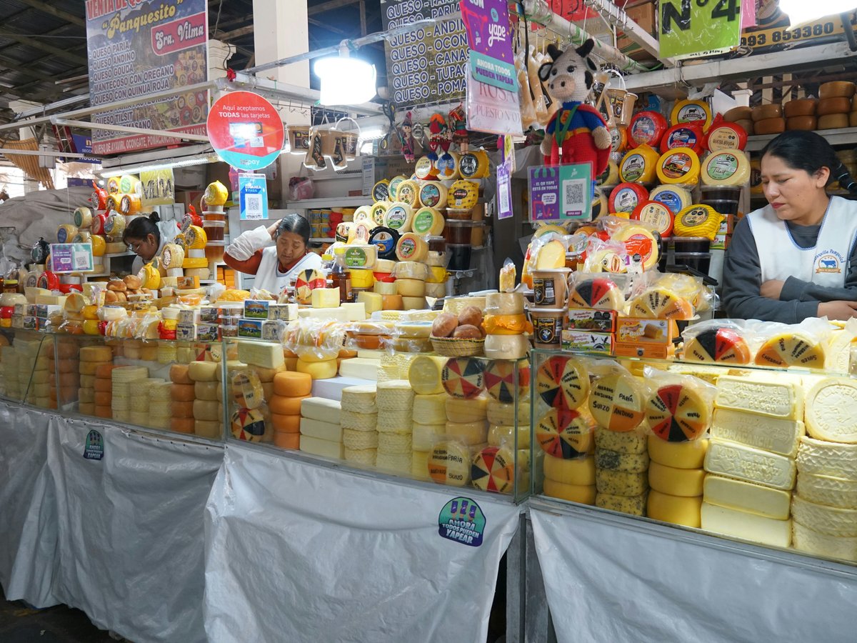 A market stall piled high with many cheeses